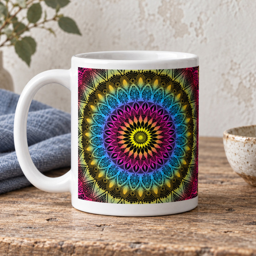 Colorful mug with pink blue and yellow mandala close-up on a rustic wooden table