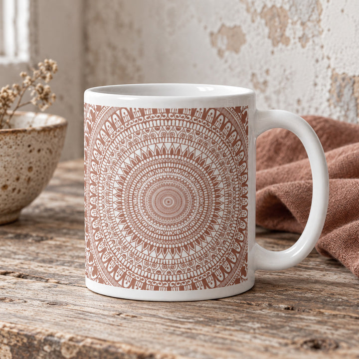 Close-up of terracotta mehndi mandala mug in a rustic boho setting