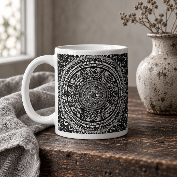 11 oz black and white mandala mug styled on a rustic wooden table