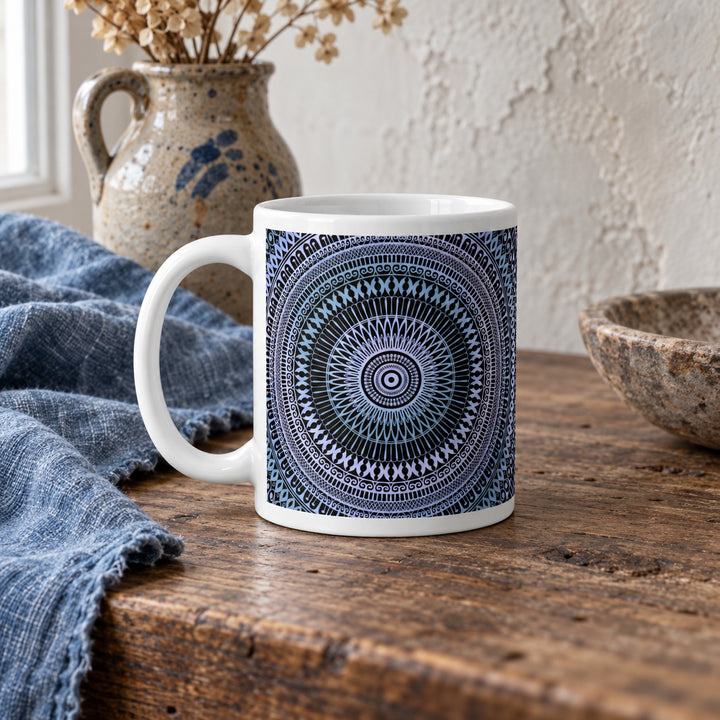 11 oz pale blue and soft pink mandala mug styled on a rustic vintage wooden table