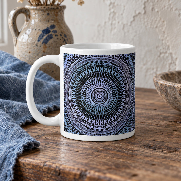 Close-up of pale blue and soft pink mandala mug in a rustic boho setting
