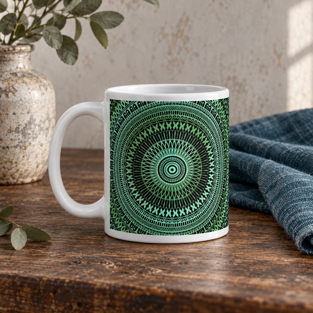 11 oz blue green decorative mandala mug styled on a rustic vintage wooden table