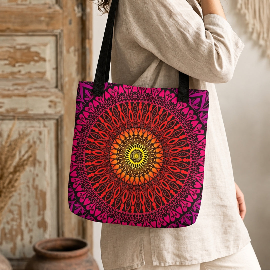 Orange red and pink mandala tote bag worn by a woman, close-up