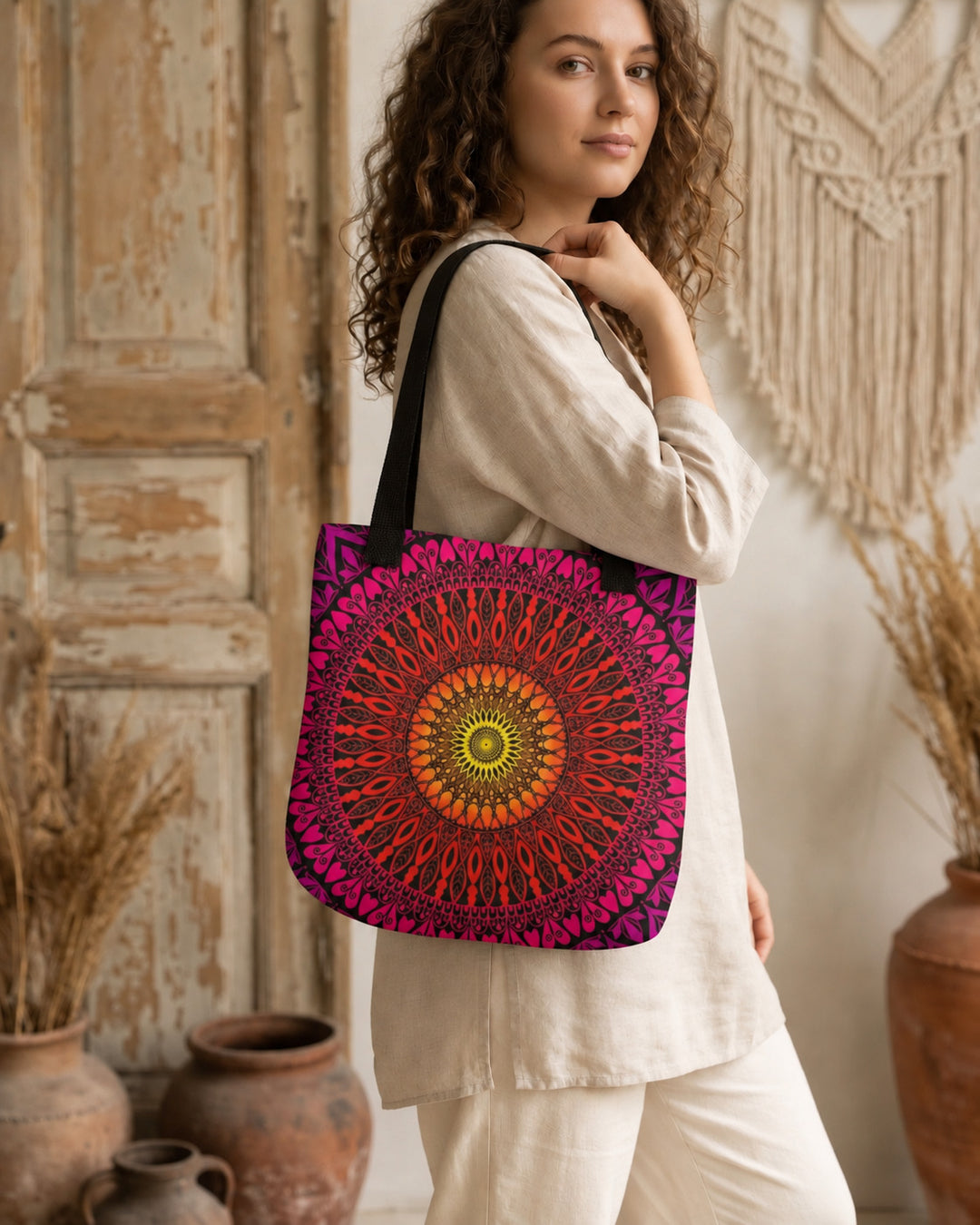 Orange red and pink mandala tote bag worn by a woman in a boho lifestyle setting