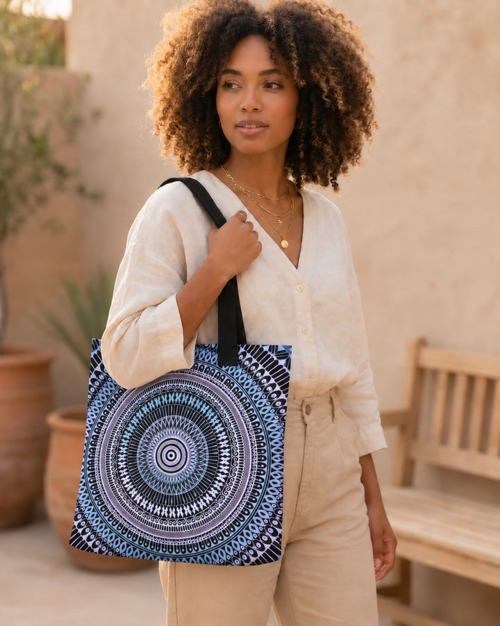 Pastel blue and pink mandala tote bag worn by a woman in a boho lifestyle setting