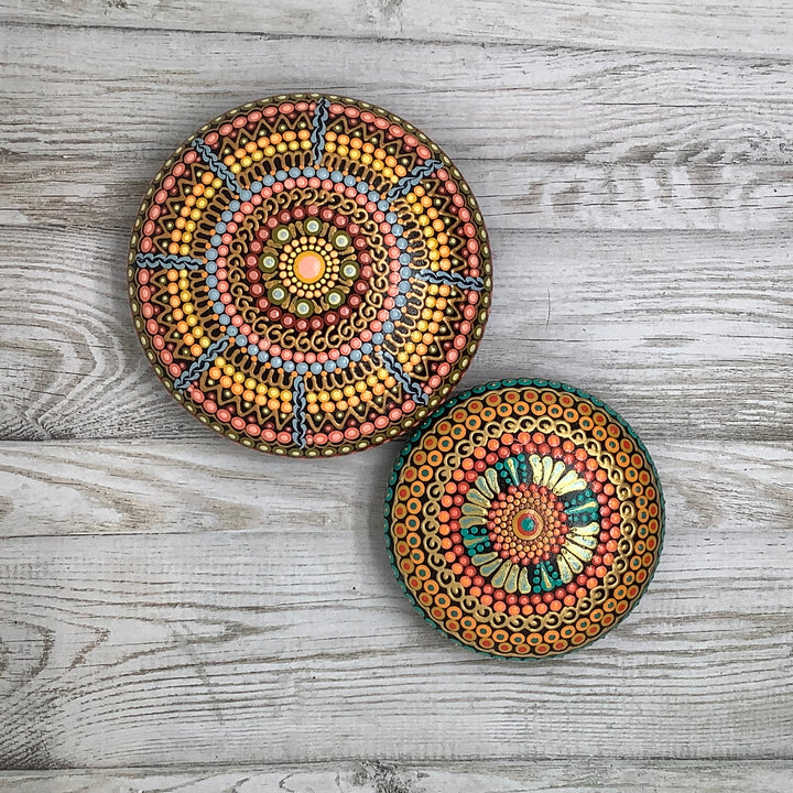 hand painted mandala stone in orange green and gold