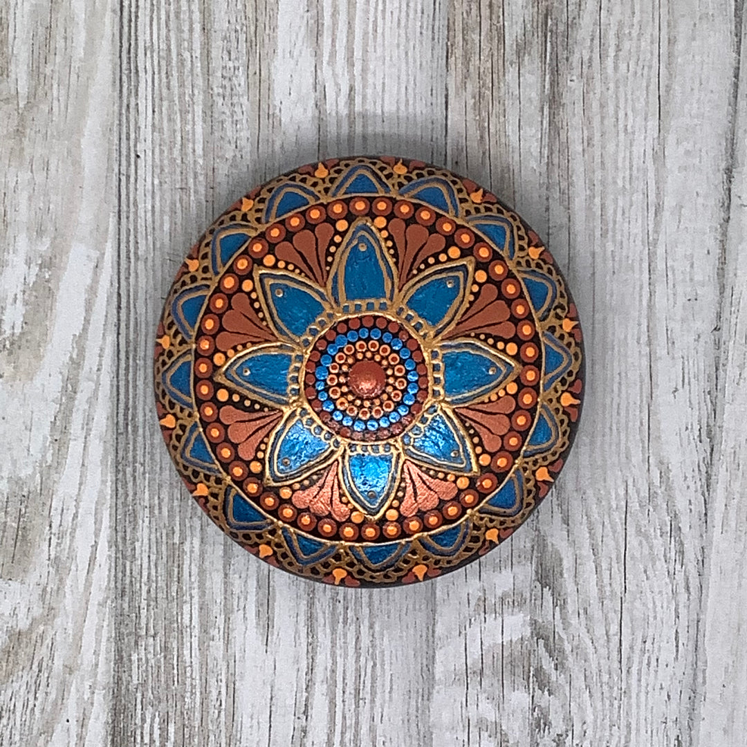 hand painted mandala stone in metallic blue and copper