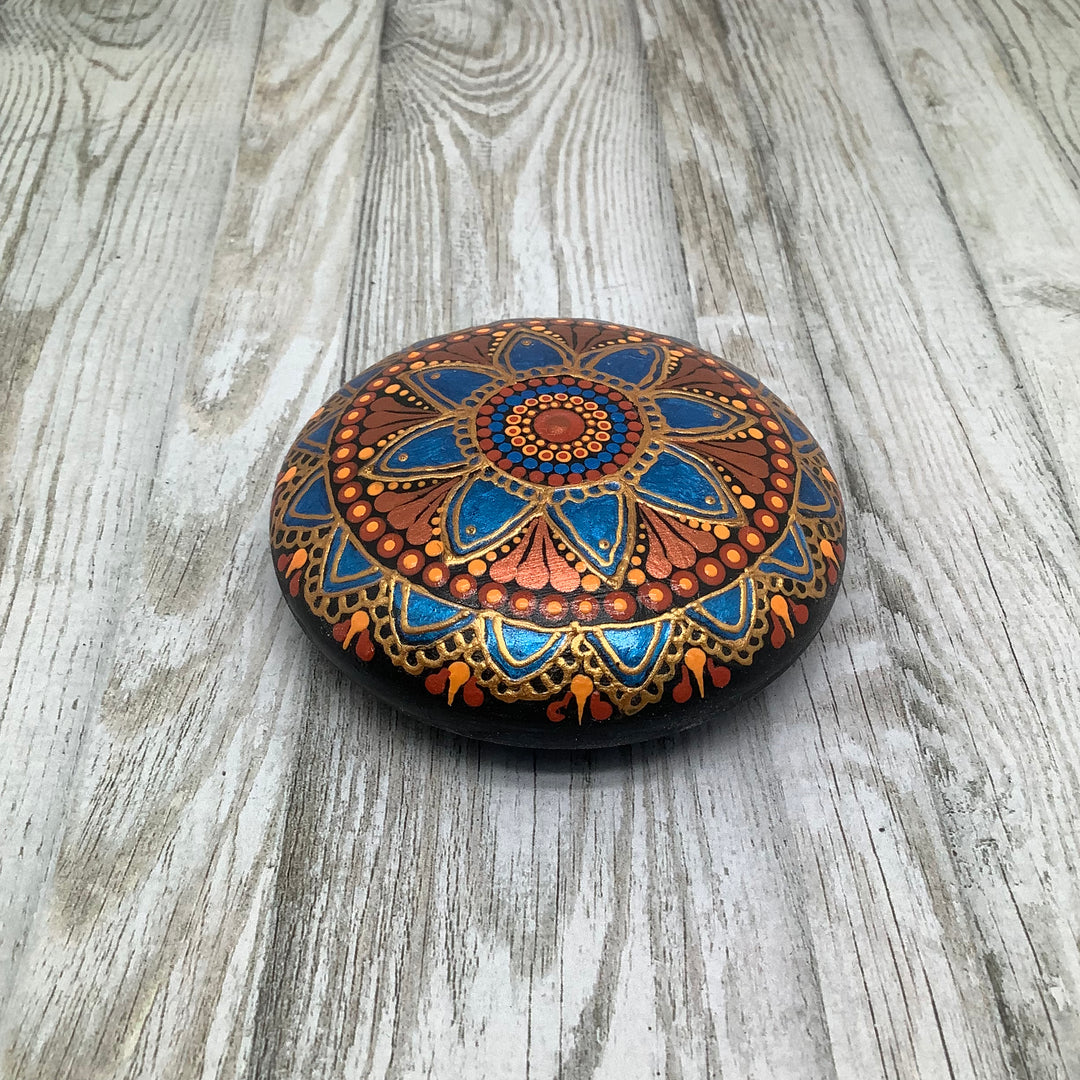 hand painted mandala stone in metallic blue and copper