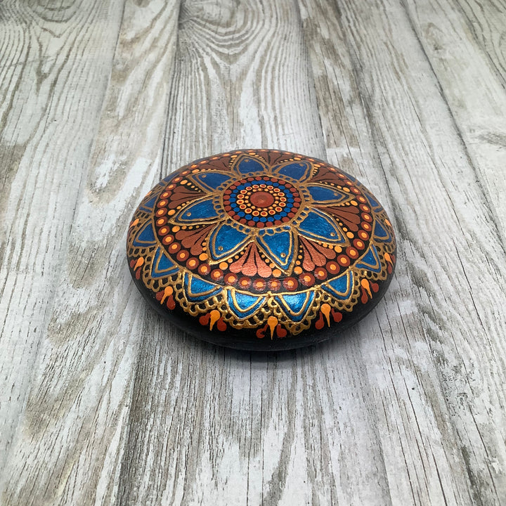 hand painted mandala stone in metallic blue and copper