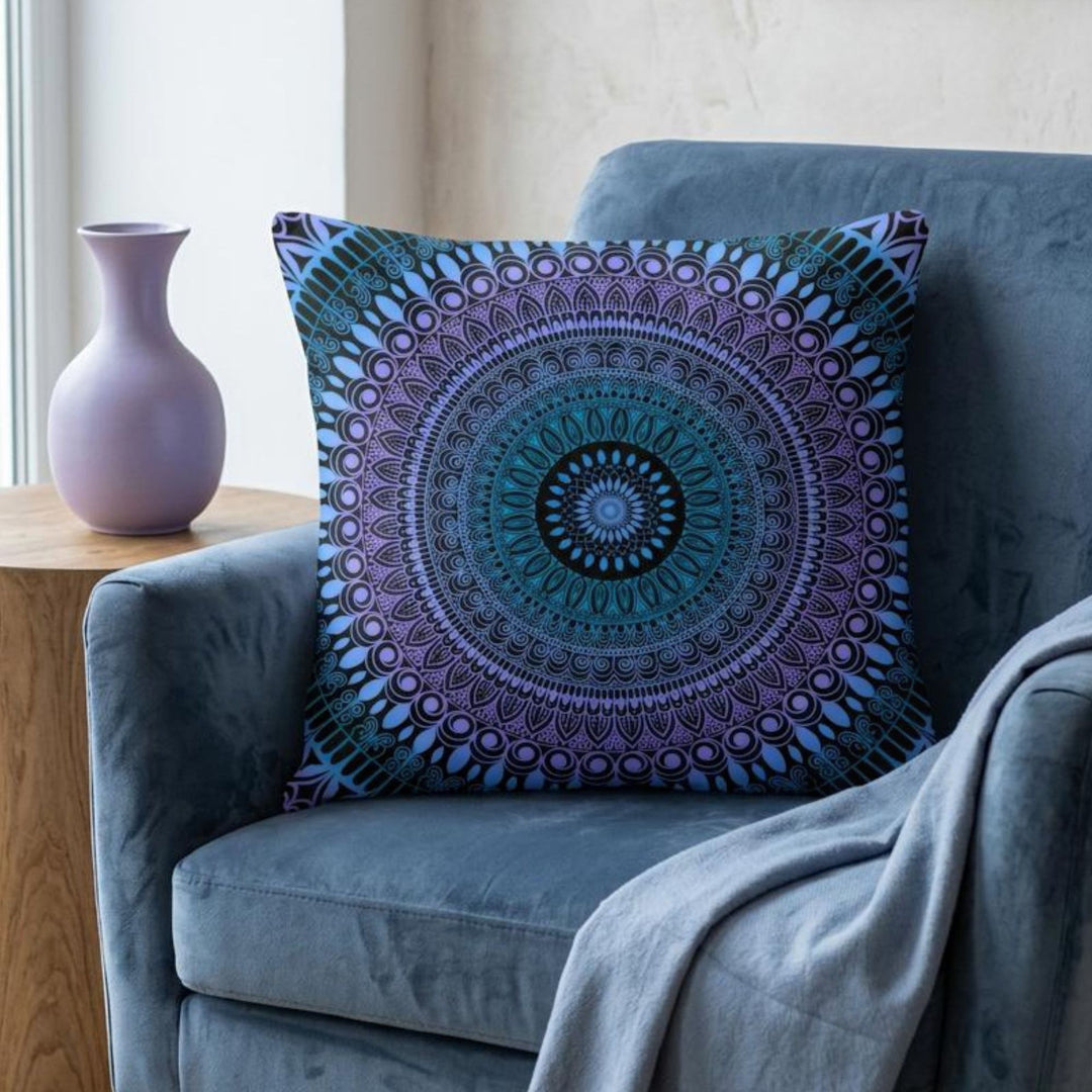 Boho square pillow cover in blue, lavender and black mandala design styled on a rich dusty blue armchair in a calm boho interior