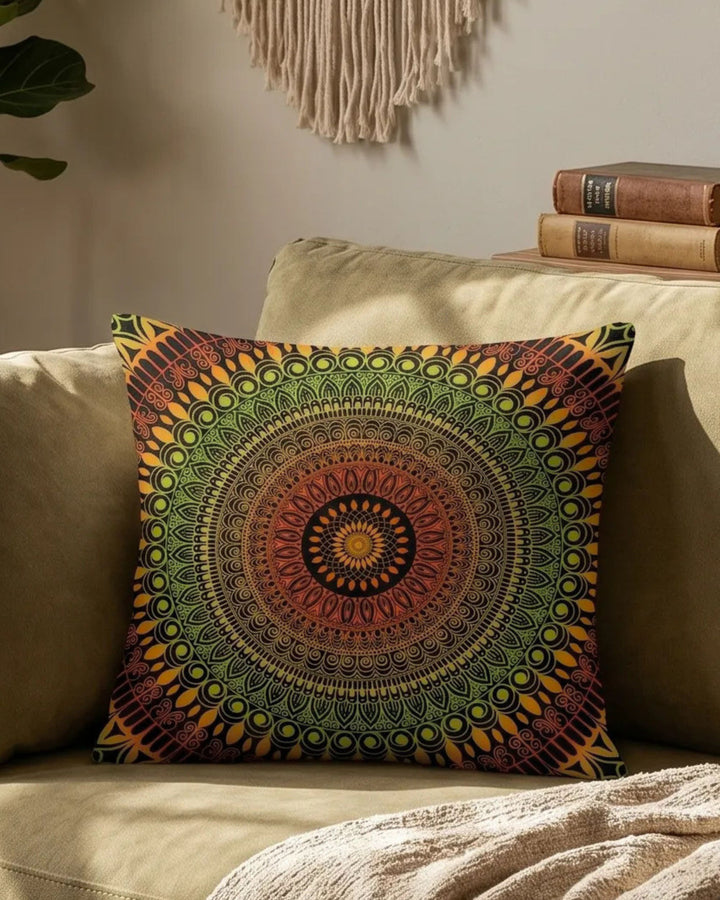 boho mandala lumbar pillow in green and orange tones on a warm beige sofa, cozy earthy interior with soft sunlight, wooden decor and neutral textures