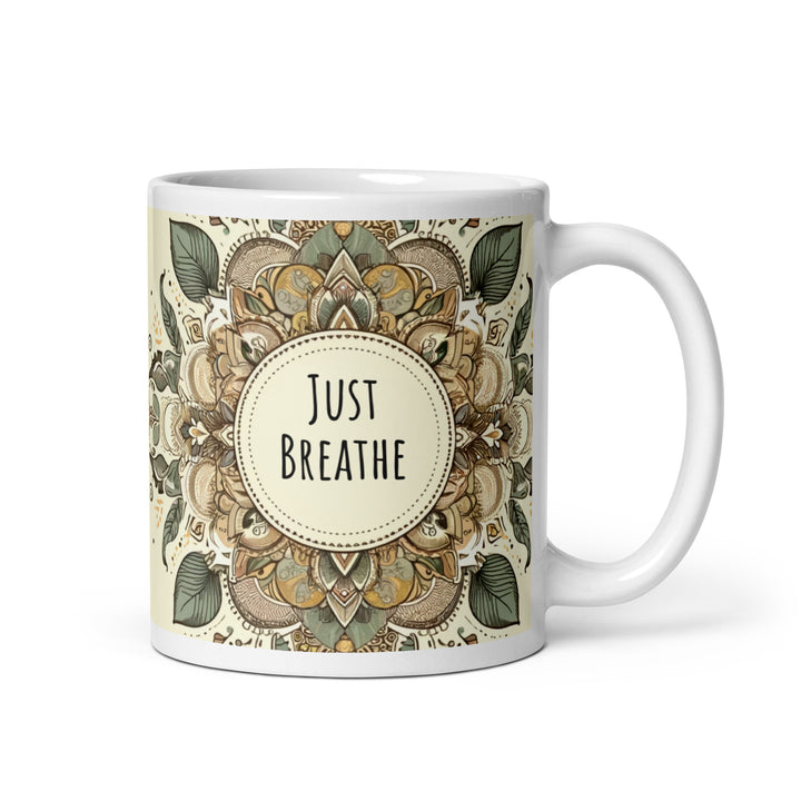 White glossy ceramic mug with a Just Breathe mandala design in beige, sage green, brown and muted gold tones, printed on both sides.