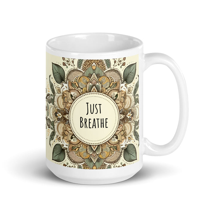 White glossy ceramic mug with a Just Breathe mandala design in beige, sage green, brown and muted gold tones, printed on both sides.